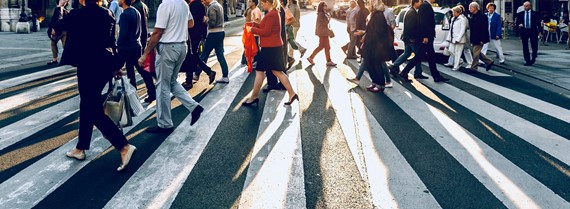 People crossing street on zebra in a city