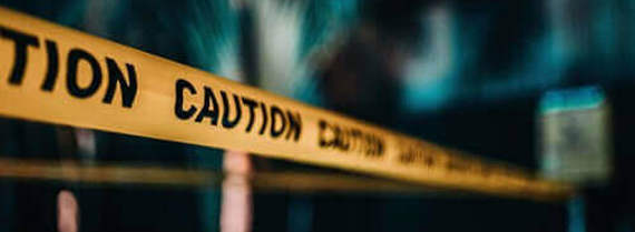 Close up of a yellow caution tape placed around perimeter.