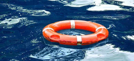 Orange life ring floating on the water.