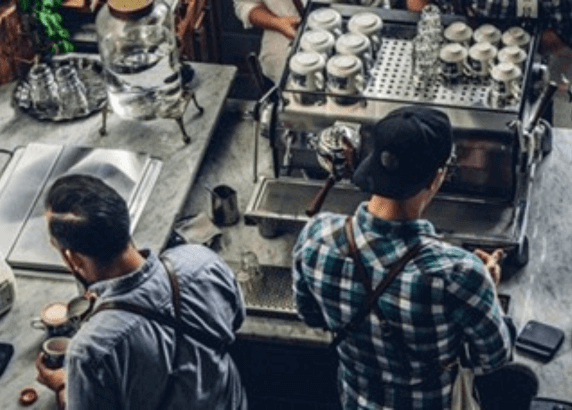 Two people working at a coffee shop.