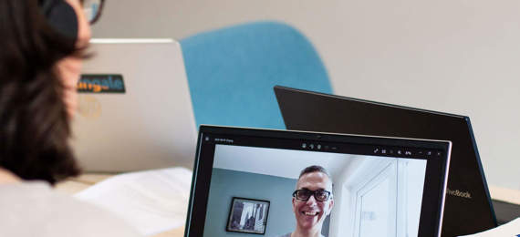 A researcher interviewing a person online.
